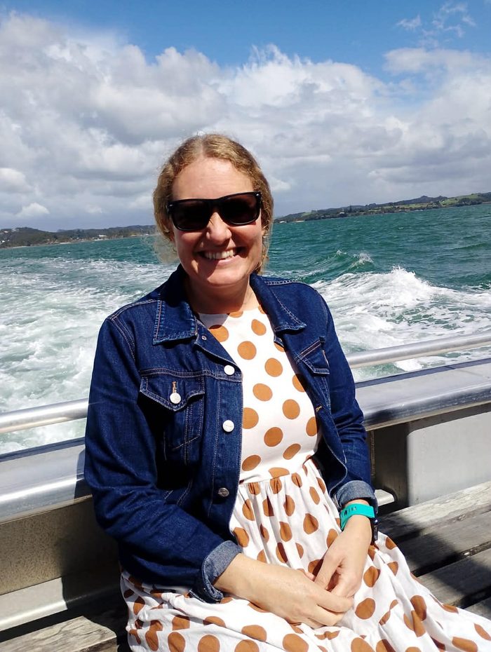 Dani smiling on a boat out on the water